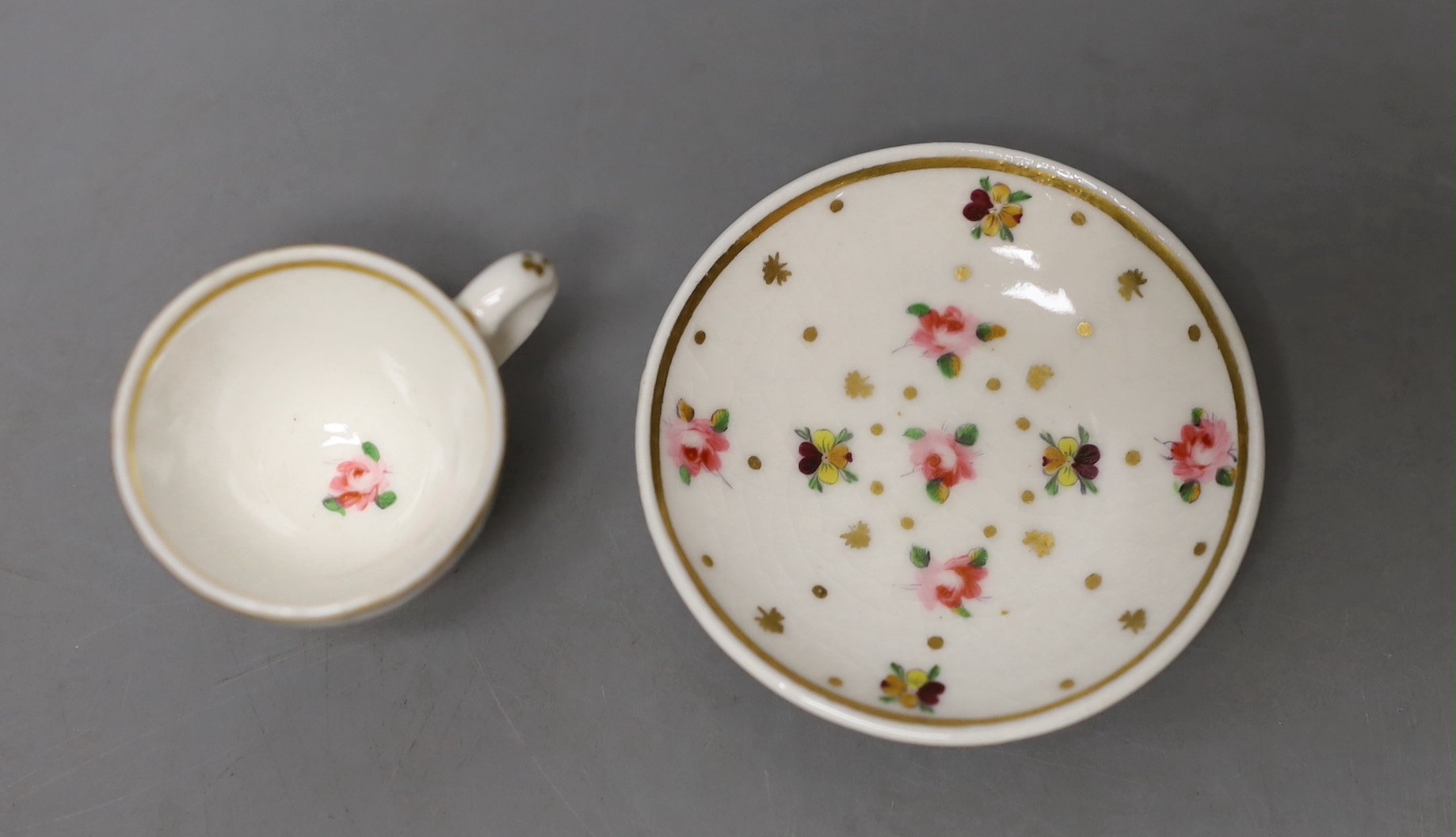 Chamberlain's miniature cup and saucer painted with flowers c.1820 - 4cm high